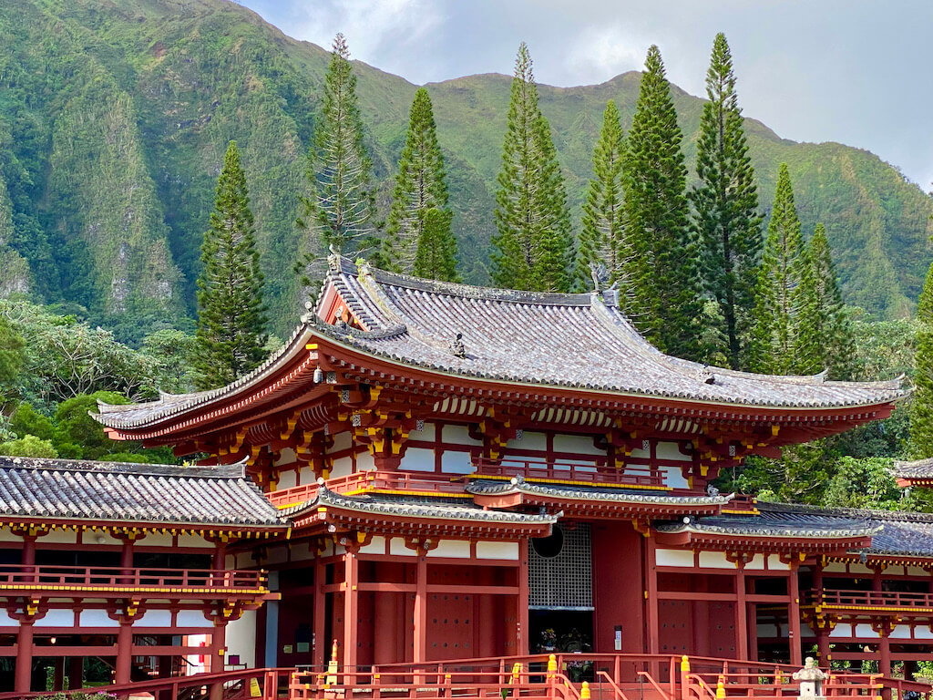 Asian temple with mountain backdrop on east side of Kauai