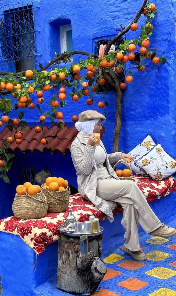 woman by orange tree in Chefchouan