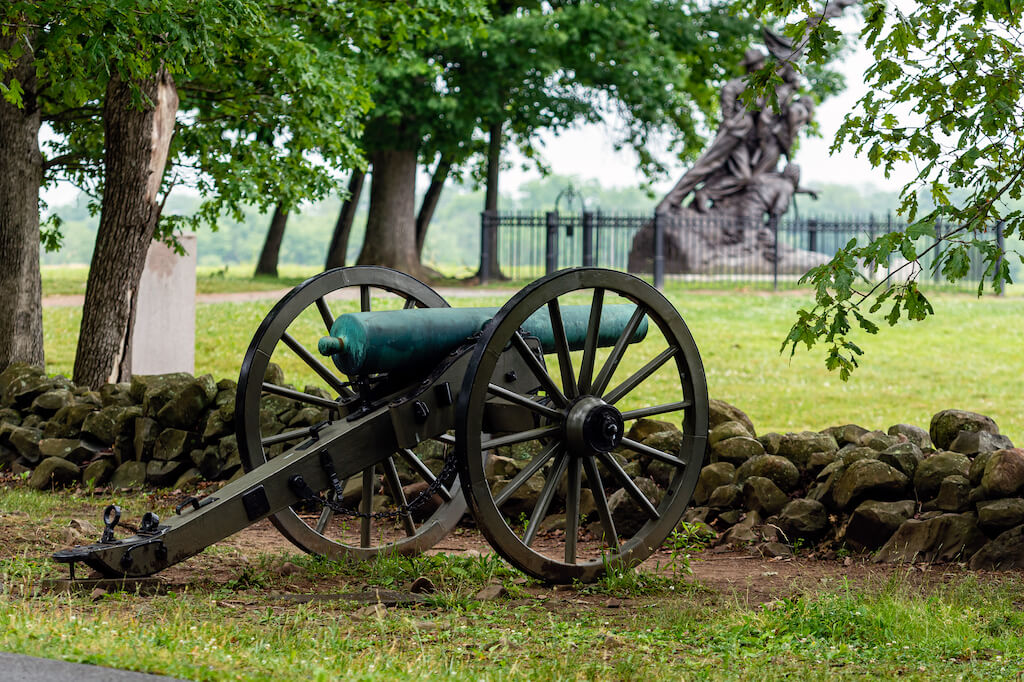 A Civil War era cannon is placed behind a stone wall in Gettysburg, PA