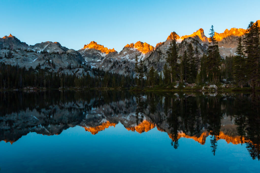 reflection of sawtooth mountains in a lake