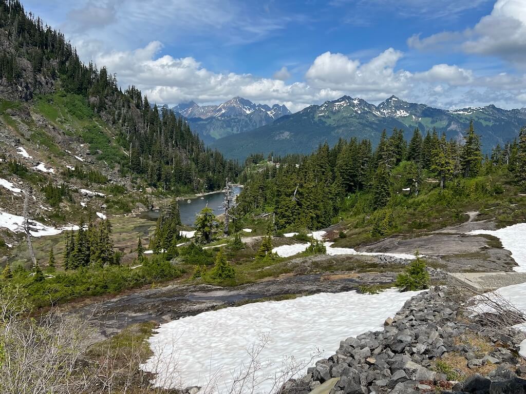 Lake near Artist Point with patches of snow at Mt Baker summit