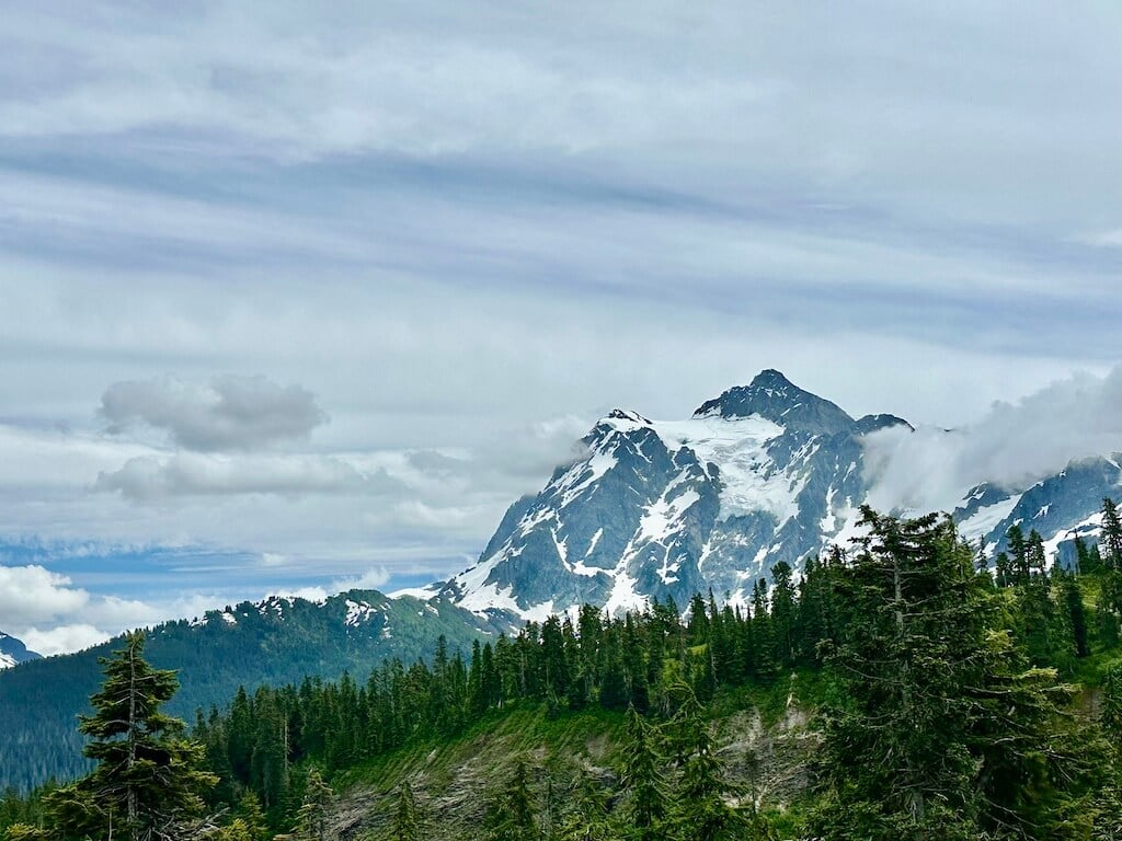 Clouds drifting across a snow covered peak