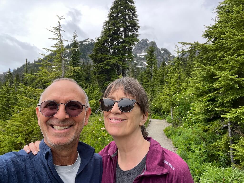 Woman and man smiling on the trail to Picture Lake
