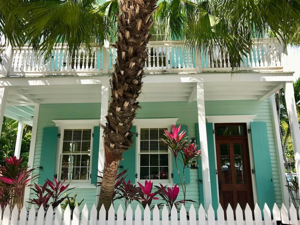 Mint green house with white picket fence and bright purple ti plans from my Key West trip
